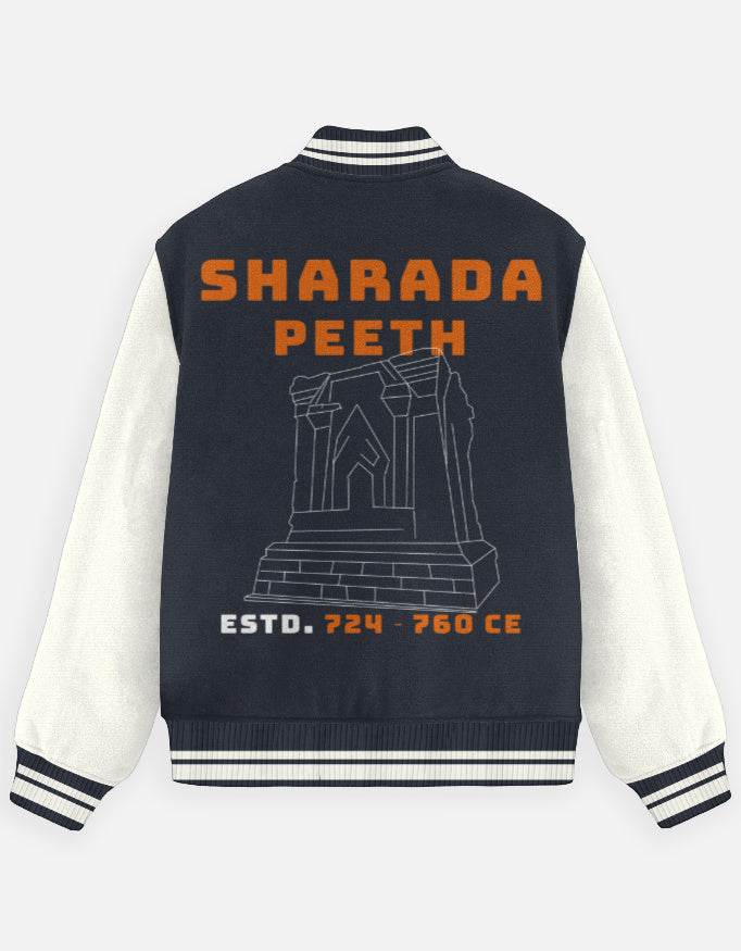 Outspoken varsity jacket with Sharada Peeth design in orange and grey on navy, showcasing Indian heritage streetwear