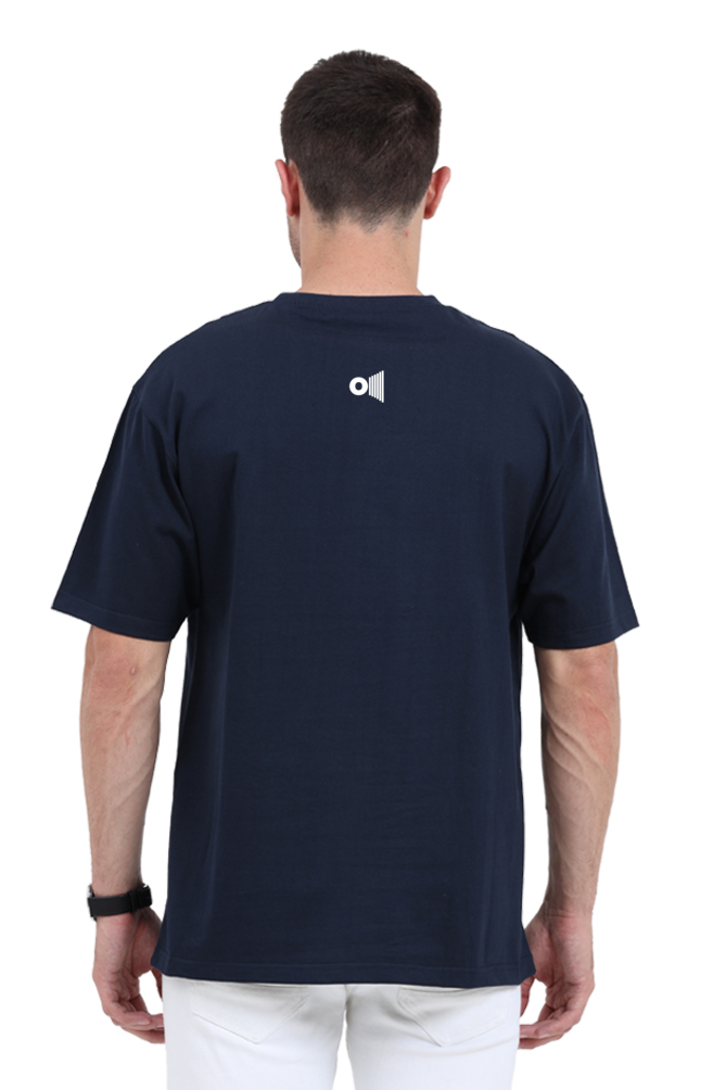 Back view of a man wearing a navy blue Outspoken Satyamev Jayate t-shirt with white pants
